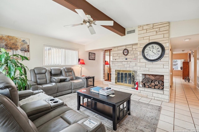 tiled living room with ceiling fan, vaulted ceiling with beams, and a stone fireplace