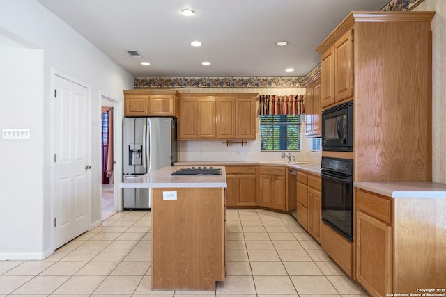 kitchen featuring black appliances, a center island, light tile patterned floors, and decorative backsplash