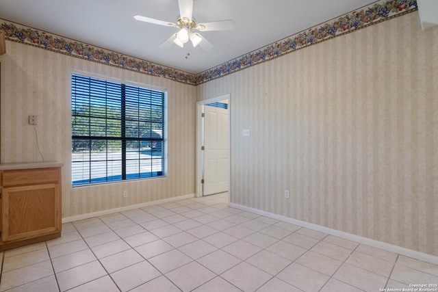 unfurnished room featuring light tile patterned floors and ceiling fan