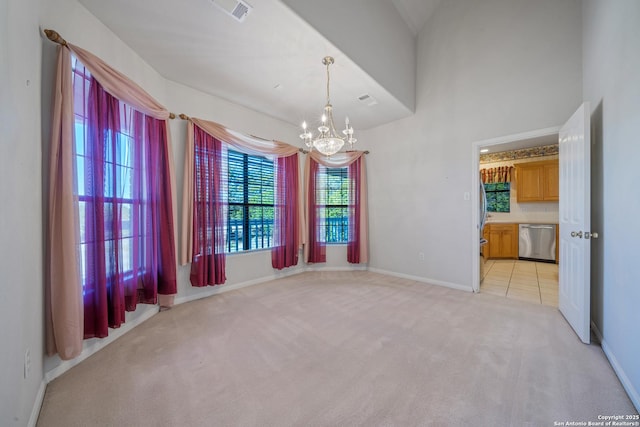 unfurnished room with a chandelier and light colored carpet