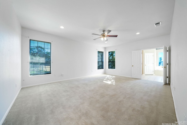 empty room featuring light colored carpet and ceiling fan