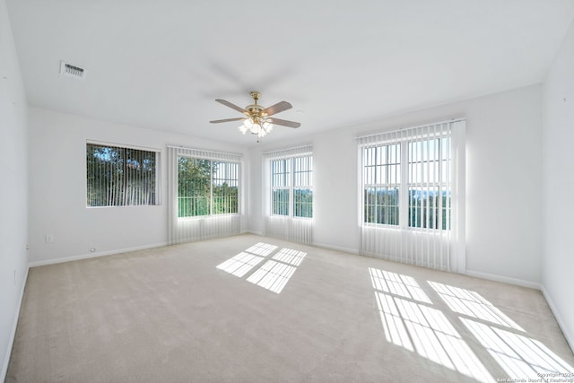 carpeted empty room featuring ceiling fan