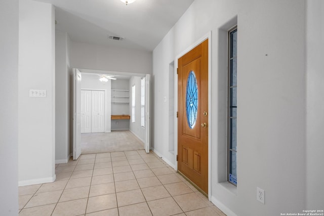 tiled entrance foyer with ceiling fan