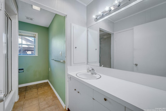 bathroom featuring walk in shower, vanity, and tile patterned flooring