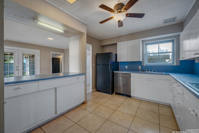 kitchen with white cabinets, dishwasher, french doors, sink, and black fridge