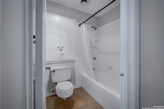 bathroom featuring toilet, shower / bath combo, and tile patterned floors