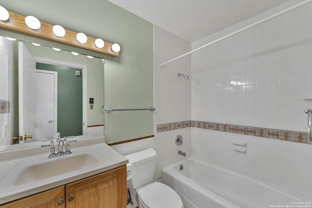 full bathroom featuring toilet, vanity, and tiled shower / bath