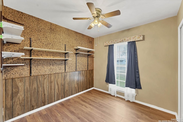 unfurnished room featuring ceiling fan and hardwood / wood-style flooring