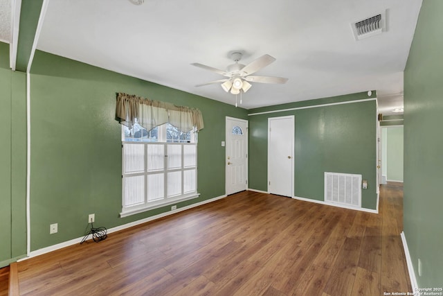 spare room featuring ceiling fan and wood-type flooring