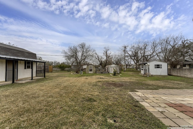 view of yard featuring a patio and a storage unit