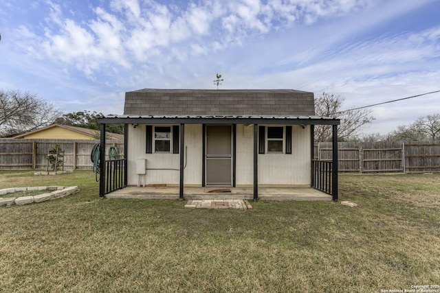 exterior space featuring a lawn and an outbuilding