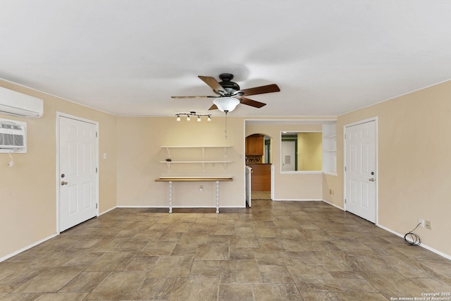 unfurnished living room featuring ceiling fan and an AC wall unit