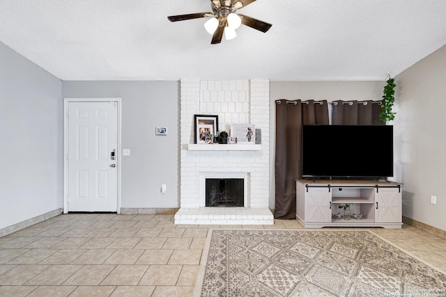 unfurnished living room featuring ceiling fan, light tile patterned floors, a fireplace, and a textured ceiling