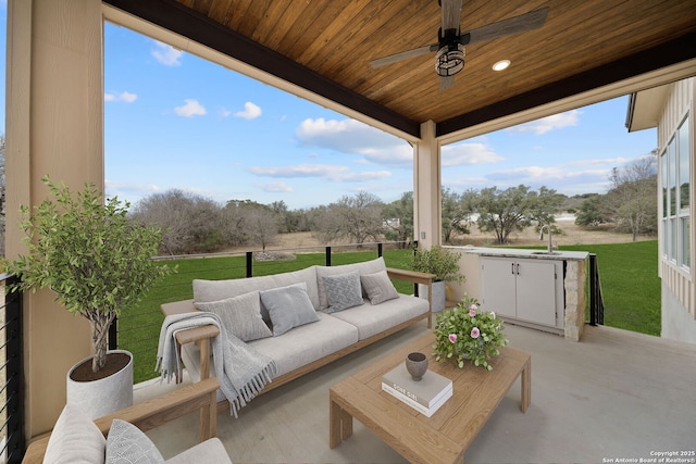 view of patio featuring ceiling fan, sink, and an outdoor hangout area