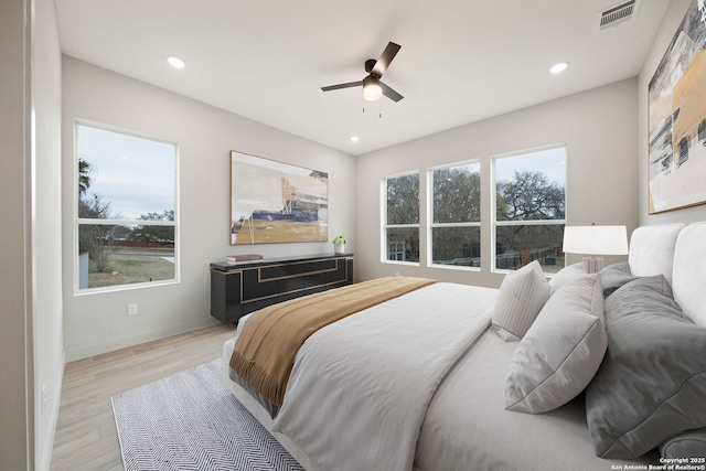 bedroom with ceiling fan and light hardwood / wood-style floors