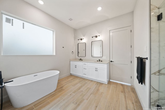 bathroom with vanity and independent shower and bath