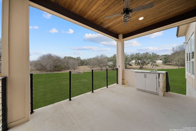 view of patio / terrace featuring ceiling fan and sink