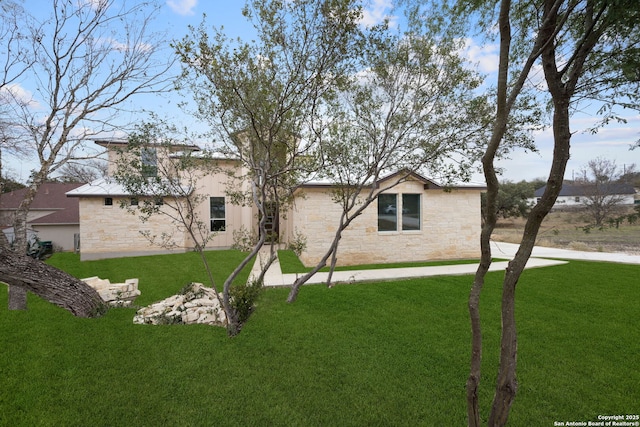 back of house with a lawn