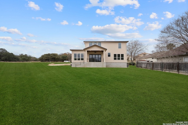 rear view of property with a lawn