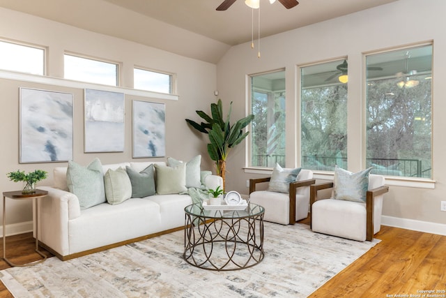 living room with ceiling fan, lofted ceiling, and hardwood / wood-style floors