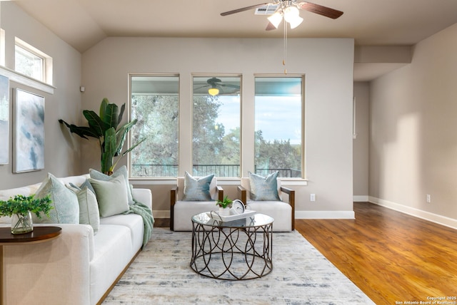 living room featuring vaulted ceiling, ceiling fan, a wealth of natural light, and hardwood / wood-style floors