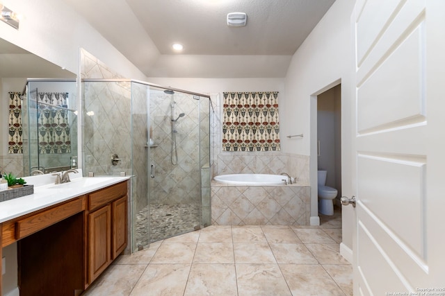 full bathroom featuring toilet, tile patterned flooring, separate shower and tub, and vanity