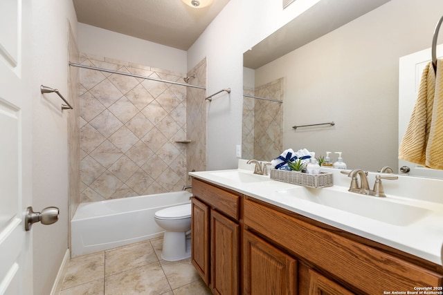 full bathroom featuring toilet, tiled shower / bath combo, tile patterned floors, and vanity