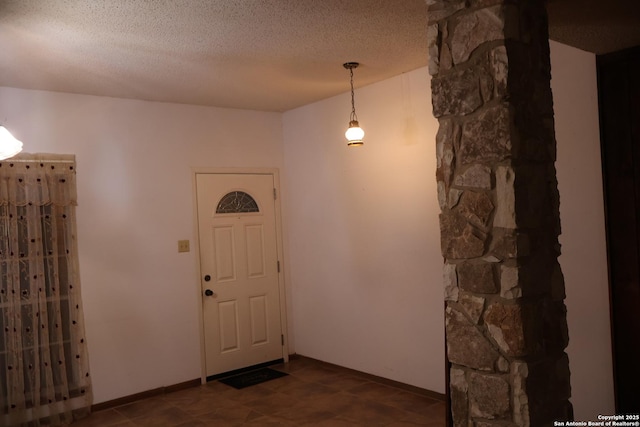 foyer entrance featuring a textured ceiling