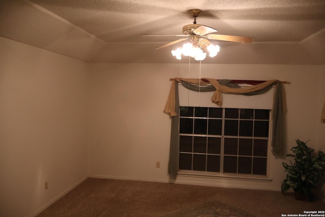 carpeted empty room featuring ceiling fan and a textured ceiling