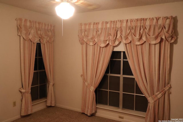 interior space with carpet floors and ceiling fan