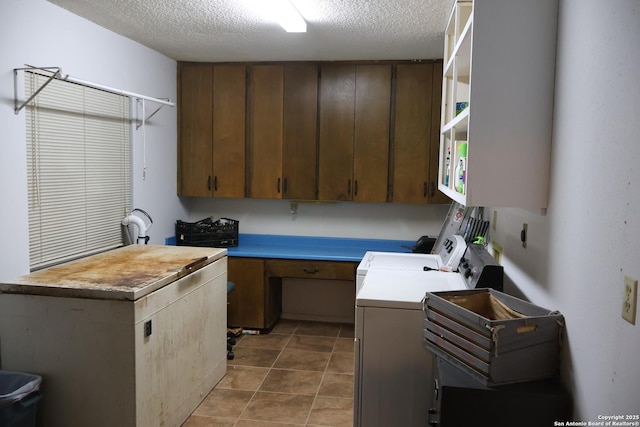 kitchen featuring washer and dryer and a textured ceiling