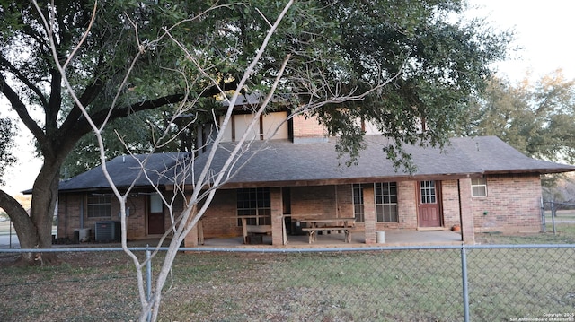 back of property featuring a lawn, central AC, and a patio area