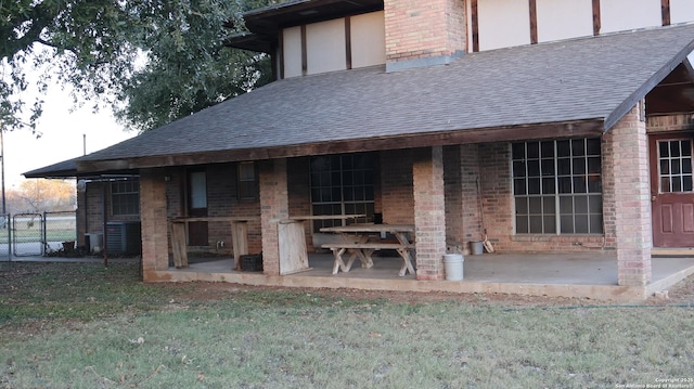 rear view of property with central AC unit and a patio