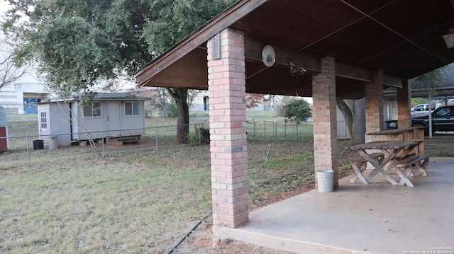 view of yard with an outbuilding and a patio