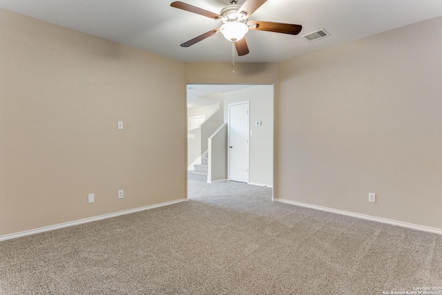 carpeted spare room featuring ceiling fan