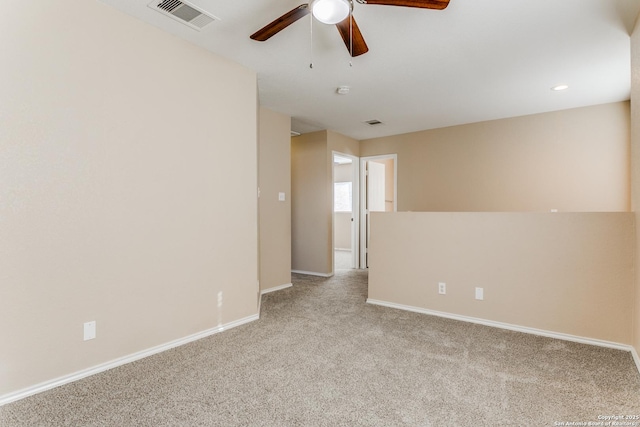 empty room with ceiling fan and light colored carpet