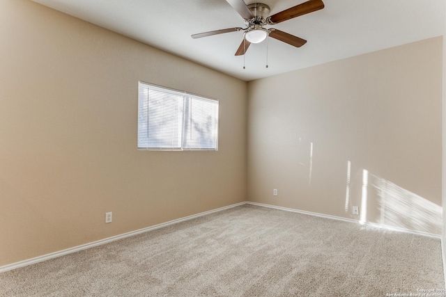 carpeted spare room with ceiling fan