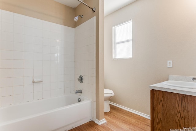 full bathroom featuring hardwood / wood-style floors, toilet, vanity, and bathing tub / shower combination