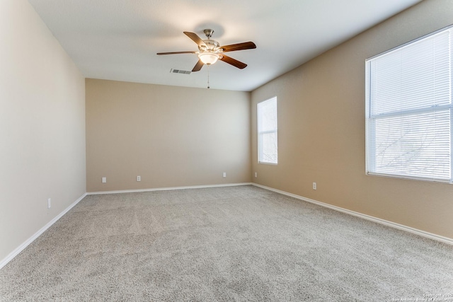 carpeted empty room featuring ceiling fan