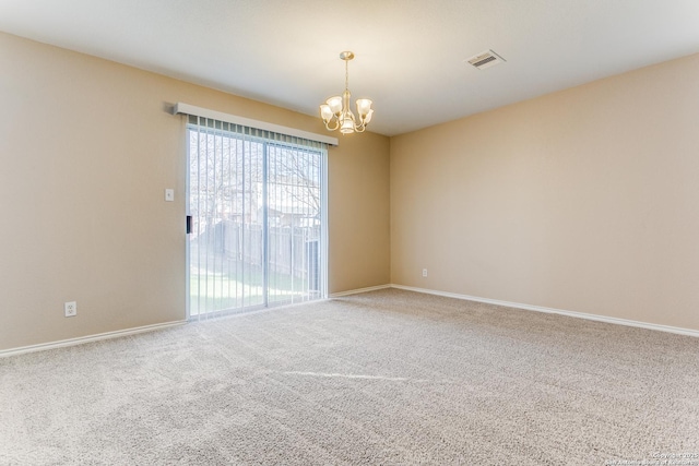 unfurnished room featuring carpet floors and a chandelier