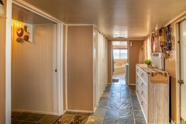 hall with wooden ceiling and wood walls