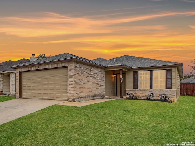 prairie-style house with a garage and a yard