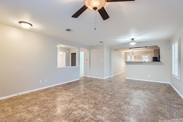 unfurnished living room featuring ceiling fan