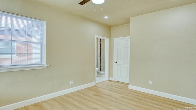 spare room with light hardwood / wood-style floors and ceiling fan