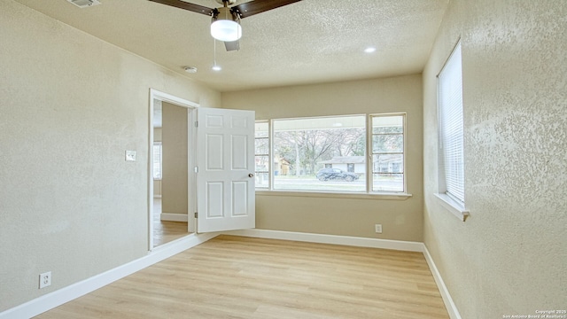 unfurnished bedroom with a textured ceiling, ceiling fan, and light hardwood / wood-style floors