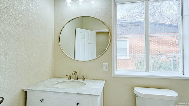 bathroom featuring toilet and vanity