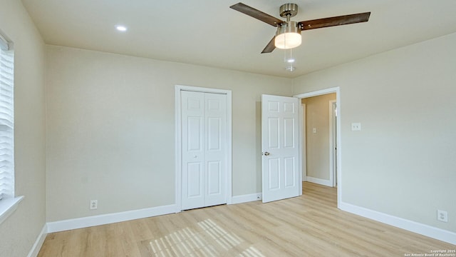 unfurnished bedroom with ceiling fan, a closet, and light hardwood / wood-style floors