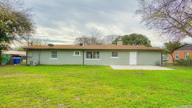 rear view of property with a yard and a patio