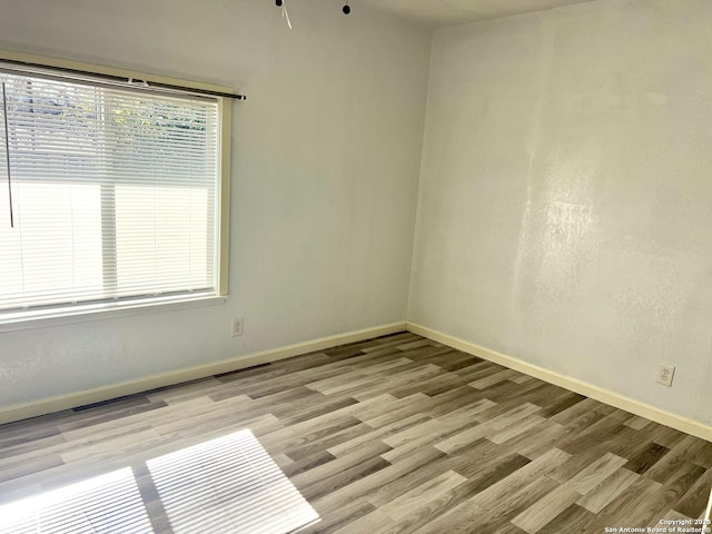 unfurnished room featuring light hardwood / wood-style floors