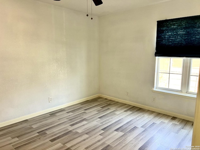 empty room featuring light wood-type flooring and ceiling fan